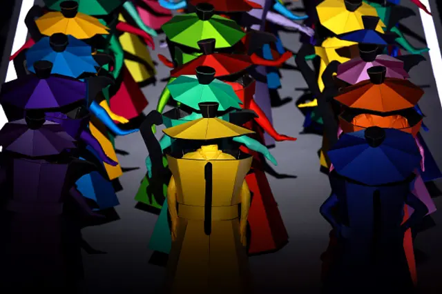 Actors dressed as a symbol of Italian design perform during the opening ceremony