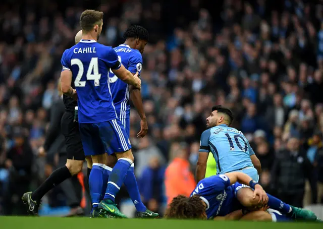 Aguero looks at the ref as Luiz lays stricken