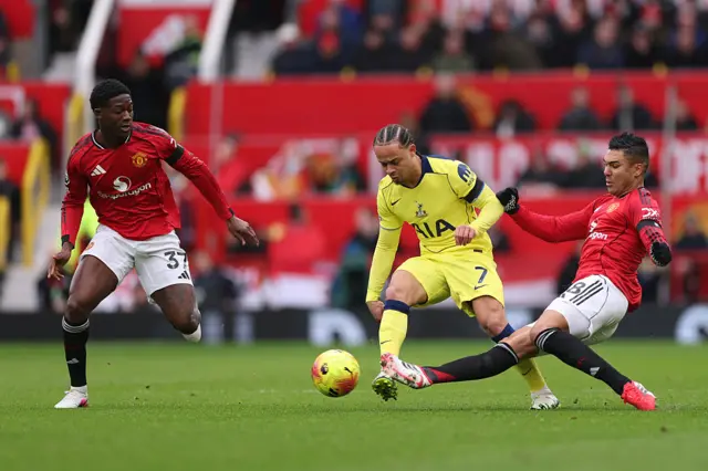Casemiro tackles Simons in midfield