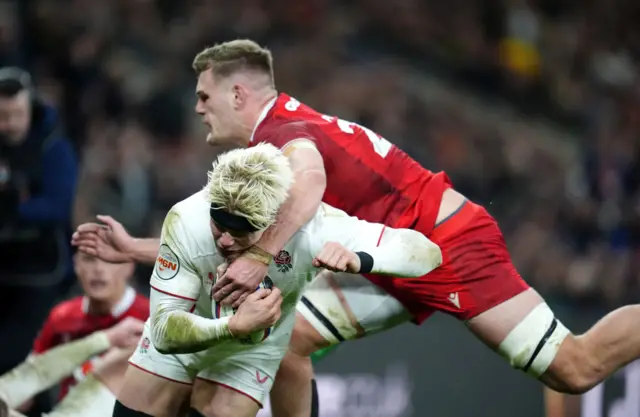Wales' Taine Plumtree attempts to tackle England's Henry Pollock as he scores their side's sixth try