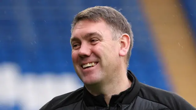 Stockport County boss Dave Challinor smiling.