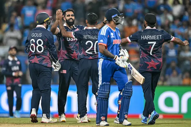 USA's Mohammad Mohsin (2L) celebrates with teammates after taking the wicket of India's Rinku Singh