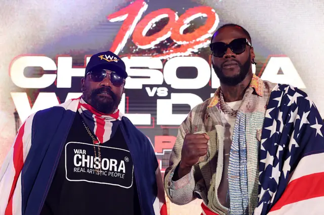Derek Chisora and Deontay Wilder stand next to each other