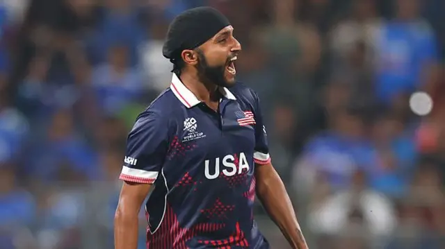 Harmeet Singh of the United States celebrates the wicket of Axar Patel of India