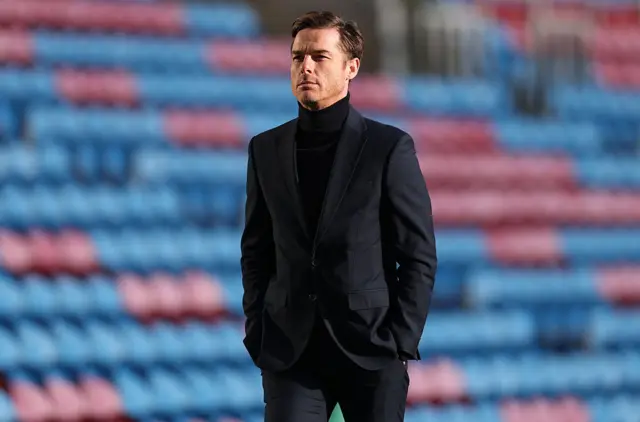 Parker walks alongside the Turf Moor pitch