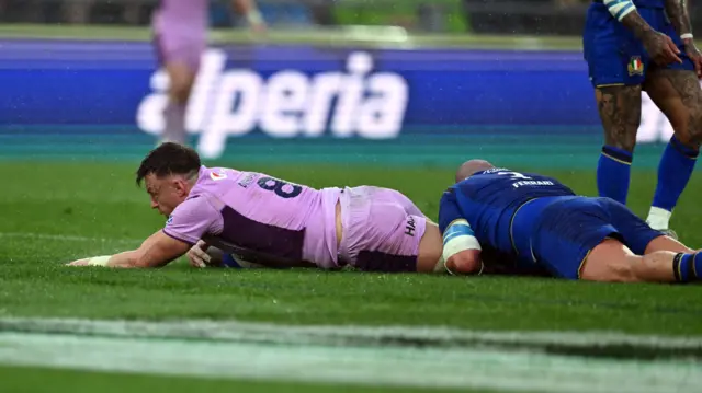 Jack Dempsey scores a try for Scotland against Italy