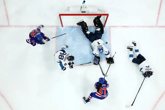 Team Finland makes a save against Abbey Murphy #37 of Team United States