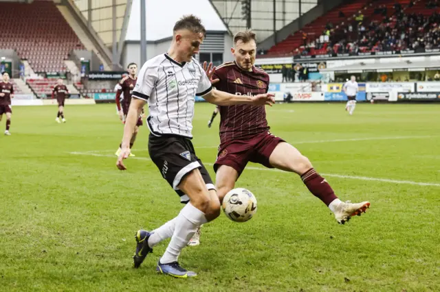 Dunfermline's Matthew Todd (L) and Kelty's James Graham in action