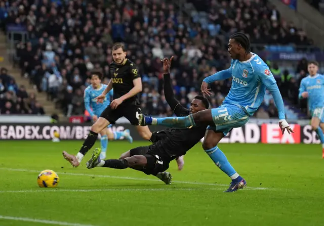 Coventry City's Haji Wright's shot is blocked by Oxford United's Christ Makosso