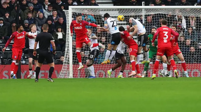 Derby captain Lewis Travis heads past his own goalkeeper against Ipswich
