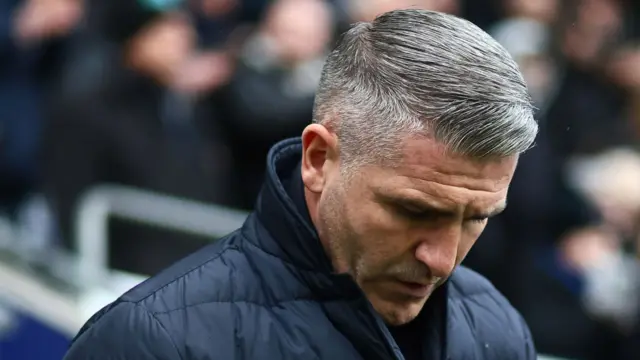 Wigan boss Ryan Lowe looks down