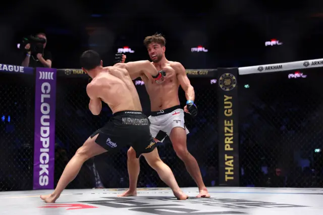 Usman Nurmagomedov lands a punch on Alfie Davis' chest