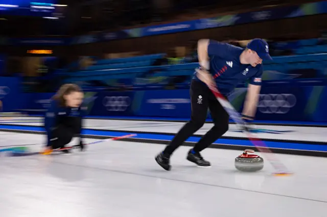 Britain's Bruce Mouat (R) competes in the curling mixed doubles