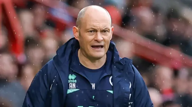 Alex Neil standing on the touchline as rain falls