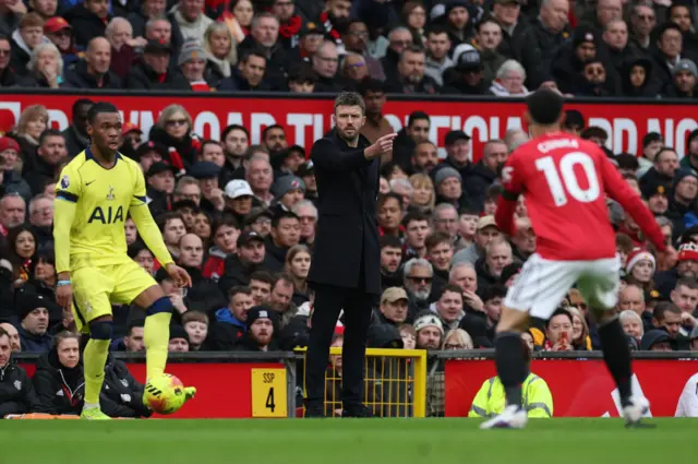 Carrick claps from the sideline