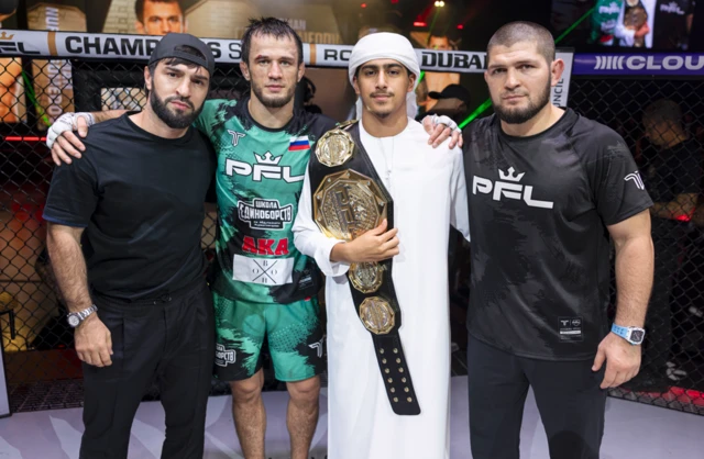 Usman Nurmagomedov celebrates with Khabib Nurmagomedov after beating Paul Hughes in October