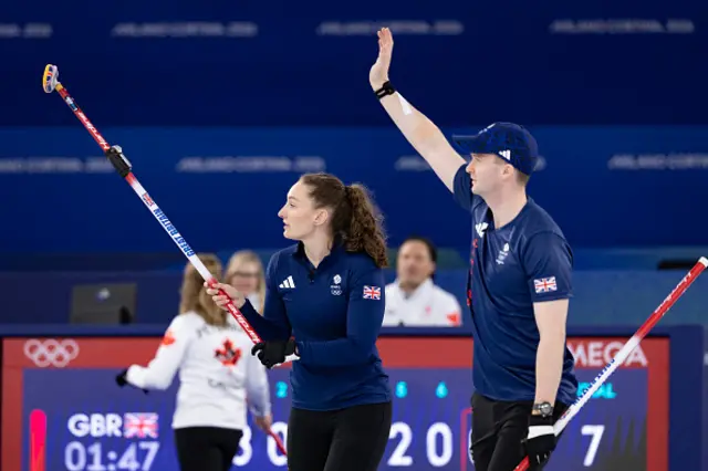 Britain's Bruce Mouat (L) and Britain's Jennifer Dodds (R) react in the curling mixed doubles
