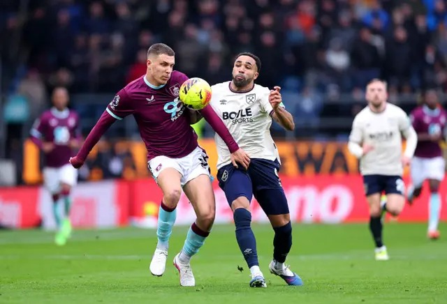 Maxime Esteve battles with Callum Wilson