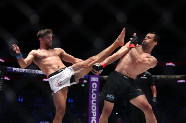 Alfie Davis throws an axe kick at Usman Nurmagomedov