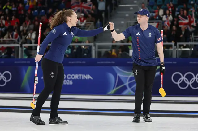 Jennifer Dodds of Team Great Britain fist bumps Bruce Mouat o