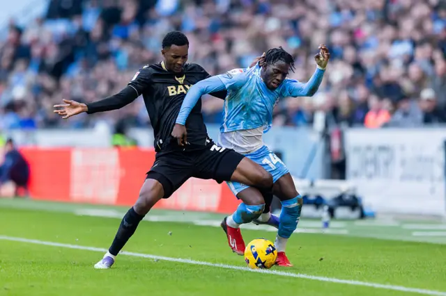 Myles Peart-Harris of Oxford United tackles Romain Esse of Coventry City
