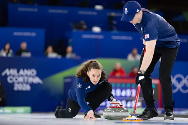 Britain's Jennifer Dodds (L) and Britain's Bruce Mouat (R) compete in the curling mixed doubles