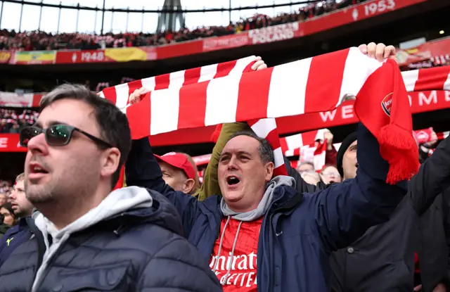 Arsenal fans sing and wave scarves pre kick off