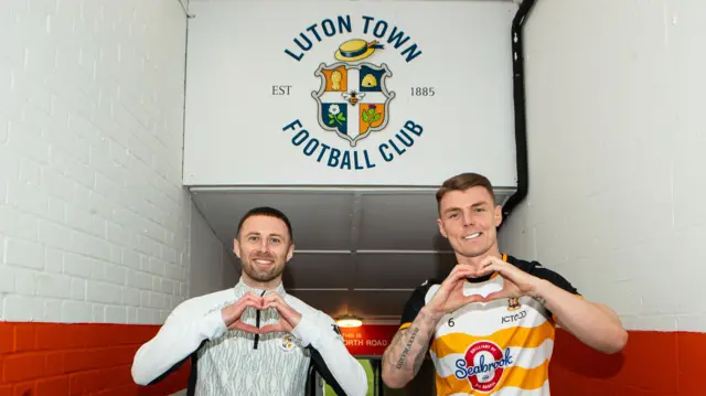 Luton captain Jordan Clark and Bradford skipper Max Power make a heart symbol for Every Minute Matters
