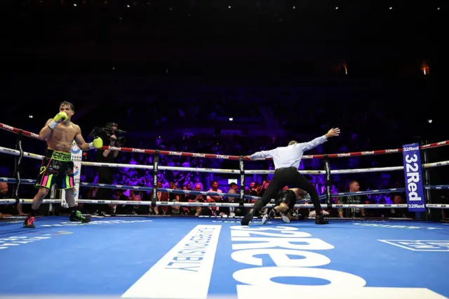Brendon Figueroa holds his hands up as the referee stands over Nick Ball who is hanging on the bottom rope
