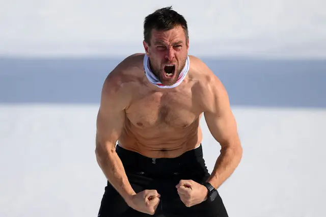 Benjamin Karl with his top off cheering