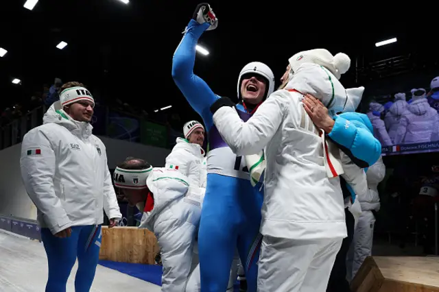 Dominik Fischnaller of Team Italy celebrates with his team staffs as his medal has been confirmed
