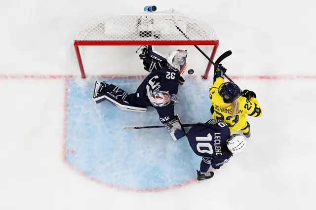 ) Thea Johansson #23 of Team Sweden scores a goal past Alice Philbert #32 of Team France in the first period