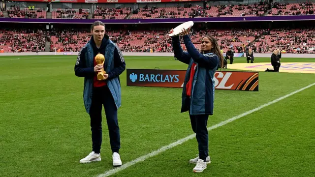 Anneke Borbe and Taylor Hinds with trophies on the Emirates pitch