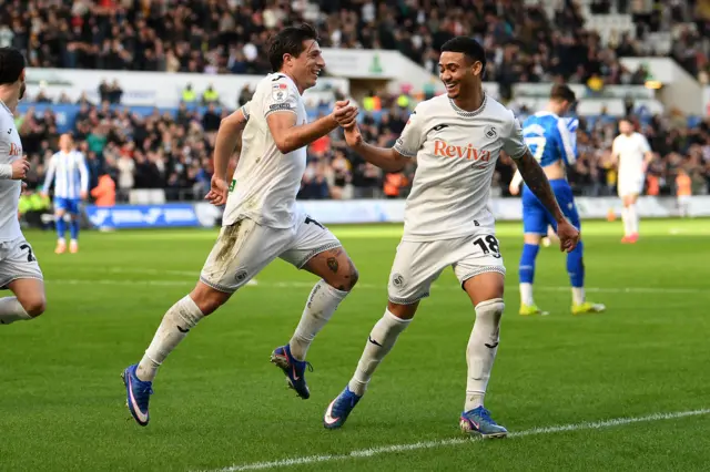 Swansea City's Goncalo Franco (left) celebrates with Gustavo Nunes