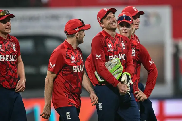 England players smile as they walk off