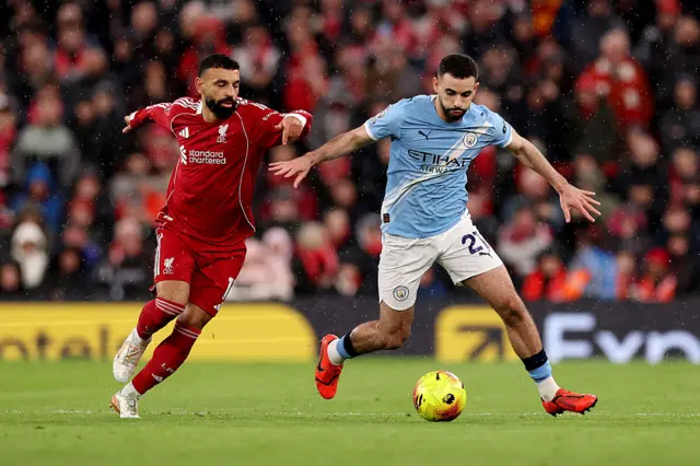 Mohamed Salah of Liverpool and Rayan Ait-Nouri of Manchester City battle for possession during the Premier League match between Liverpool and Manchester City at Anfield on February 08, 2026 in Liverpool, England.