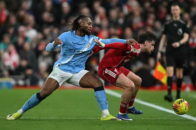 Manchester City's Matheus Nunes (left) and Liverpool's Hugo Ekitike (right) battle for the ball during the Premier League match at Anfield, Liverpool