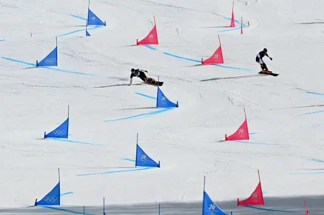 Canada's Arnaud Gaudet (L) and Bulgaria's Radoslav Yankov (R) compete in the snowboard men's parallel giant slalom last 16 run at Livigno Snow Park