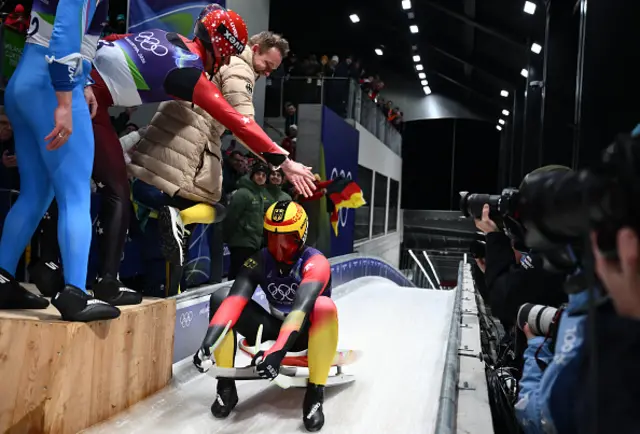 Germany's Max Langenhan celebrates in the finish area after winning the luge
