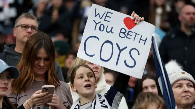 Young fan holding sign which reads 'We love you Beth COYS'
