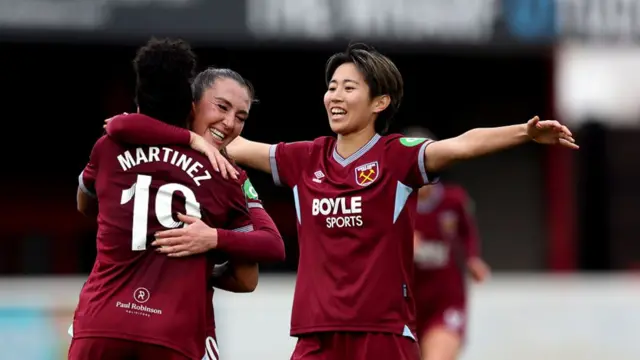 Shekiera Martinez celebrates her goal with her teammates