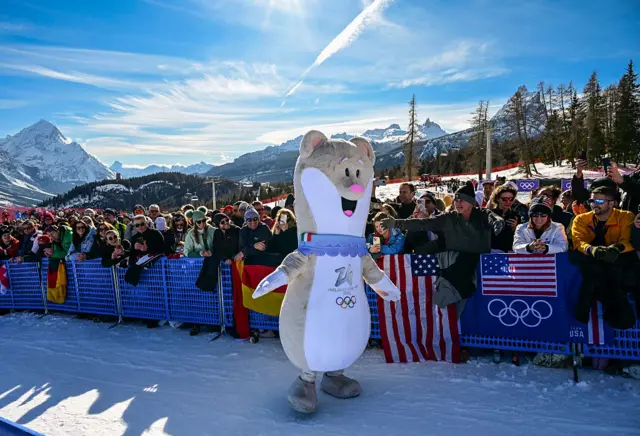 Olympic mascot Tina entertains spectators ahead of the women's downhill event during the Milano Cortina 2026 Winter Olympic Games