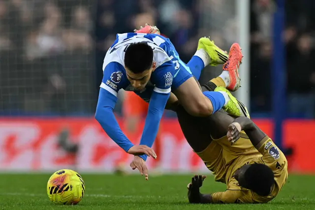 Brighton's Paraguayan midfielder #25 Diego Gomez (L) vies with Crystal Palace's Senegalese midfielder #07 Ismaila Sarr (R) during the English Premier League football match between Brighton and Hove Albion and Crystal Palace at the American Express Community Stadium in Brighton, southern England on February 8, 2026.