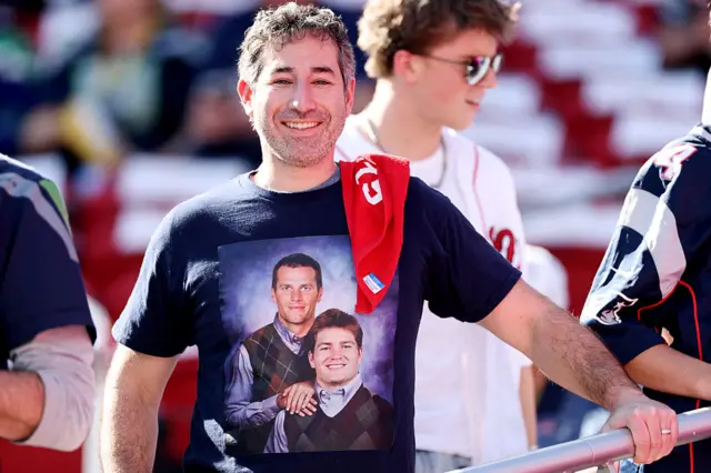 A fan wearing a T-shirt with Tom Brady and Drake Maye on