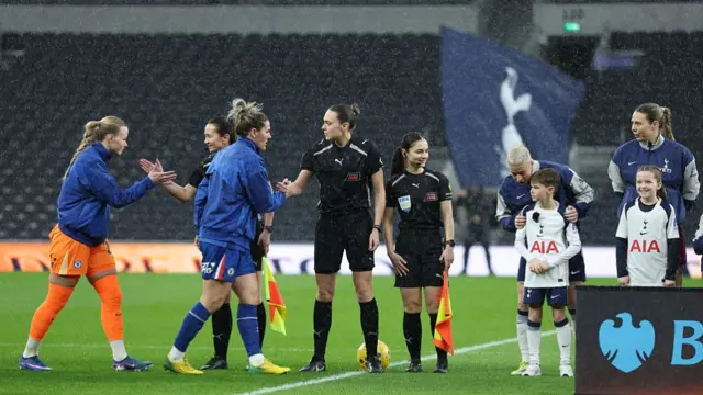 Millie Bright shakes the officials' hands