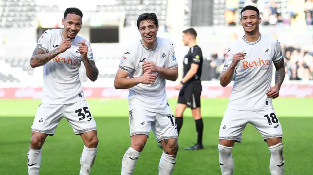 Swansea players celebrate the opening goal