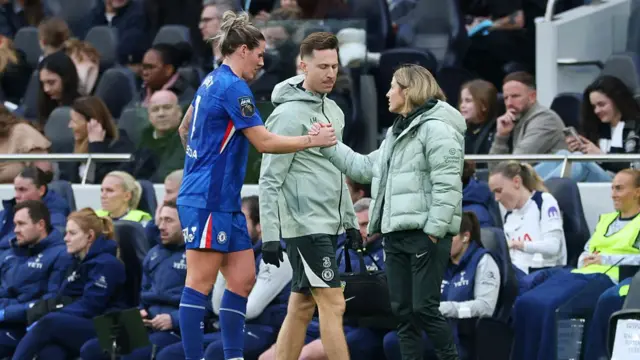Millie Bright interacts with Sonia Bompastor on the sidelines