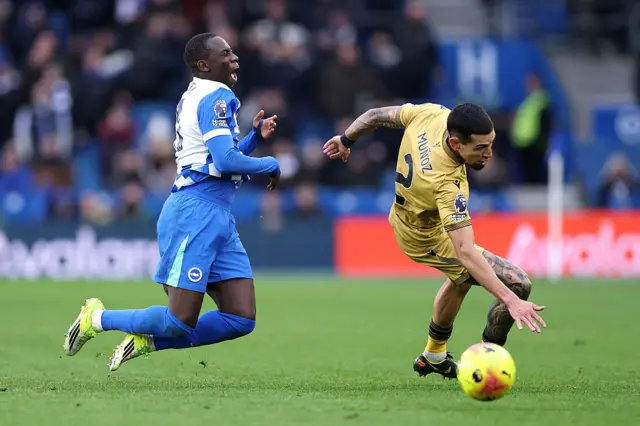Daniel Munoz of Crystal Palace is challenged by Yankuba Minteh of Brighton & Hove Albion during the Premier League match between Brighton & Hove Albion and Crystal Palace at Amex Stadium on February 08, 2026 in Brighton, England.