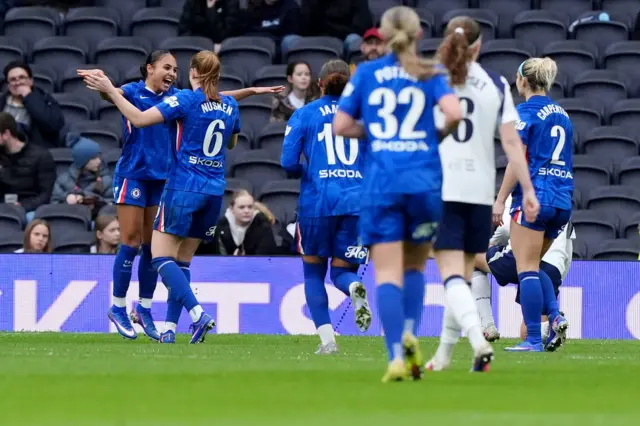 Thompson celebrates with teammates after scoring the second v Spurs