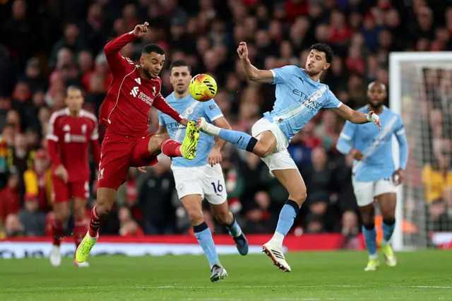Cody Gakpo of Liverpool and Matheus Nunes of Manchester City battle for possession during the Premier League match between Liverpool and Manchester City at Anfield on February 08, 2026 in Liverpool, England.